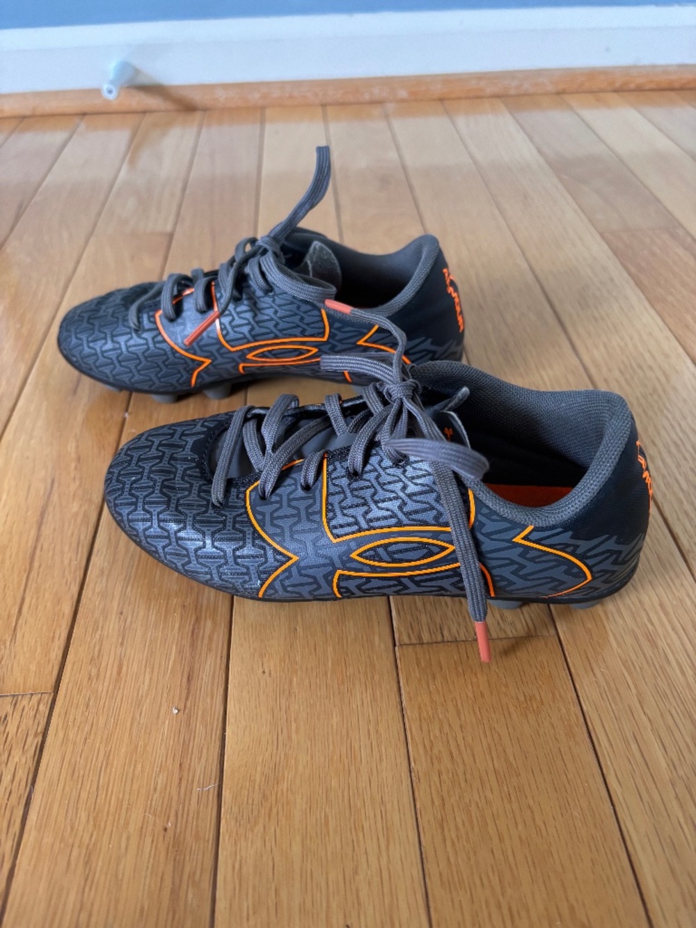 Under Armour grey and orange cleats